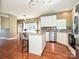 Bright kitchen with stainless steel appliances, center island, and updated counters and backsplash at 557 S Portman Ln, Fort Mill, SC 29708