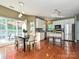 Sunlit kitchen featuring white cabinets, stainless appliances, and a center island with seating at 557 S Portman Ln, Fort Mill, SC 29708