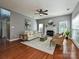 Cozy living room with a fireplace, hardwood floors, and natural light at 557 S Portman Ln, Fort Mill, SC 29708