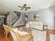 Comfortable living room featuring a sofa, hardwood floors, and staircase in view at 557 S Portman Ln, Fort Mill, SC 29708