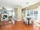 Open floor plan showing the living room with fireplace and dining area with large windows at 557 S Portman Ln, Fort Mill, SC 29708