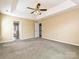 Spacious main bedroom with tray ceiling and ensuite bathroom at 557 S Portman Ln, Fort Mill, SC 29708