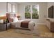 Serene bedroom with a large window offering a lush outdoor view, complemented by a stylish rug and tasteful decor at 6049 King Charles Ct, Charlotte, NC 28213