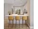 Bright kitchen features modern pendant lighting, white cabinetry, and a marble countertop island with barstool seating at 6049 King Charles Ct, Charlotte, NC 28213