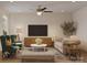 Inviting living room showcasing plush seating, modern ceiling fan and neutral tones, creating a comfortable atmosphere at 6049 King Charles Ct, Charlotte, NC 28213