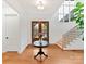 Welcoming foyer with hardwood floors, a staircase, and a view of the beautiful double-door entryway at 911 Abilene Ln, Fort Mill, SC 29715