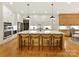 Spacious kitchen with an oversized island, modern pendant lights, and stainless steel appliances at 911 Abilene Ln, Fort Mill, SC 29715