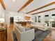 Open-concept living room with hardwood floors, wooden beams, and seamless flow to the kitchen at 911 Abilene Ln, Fort Mill, SC 29715