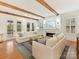 Bright and airy living room with a fireplace, wood beams, and comfortable white couches at 911 Abilene Ln, Fort Mill, SC 29715