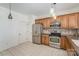 Functional kitchen featuring stainless steel appliances, wood cabinets, and tile flooring at 10015 Garrison Watch Ave # 168, Charlotte, NC 28277