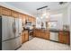Traditional kitchen featuring wood cabinets, stainless steel appliances, and tile flooring at 10015 Garrison Watch Ave # 168, Charlotte, NC 28277