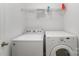 Clean laundry room with modern appliances and a wire shelf for storage at 10015 Garrison Watch Ave # 168, Charlotte, NC 28277
