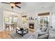 Open-concept living room featuring fireplace, hardwood floors, and adjacent dining area at 10015 Garrison Watch Ave # 168, Charlotte, NC 28277