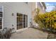 Outdoor patio area with sliding glass doors and a small garden filled with bright yellow flowers at 10015 Garrison Watch Ave # 168, Charlotte, NC 28277