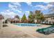 Community pool with pool house and chairs on a sunny day at 10015 Garrison Watch Ave # 168, Charlotte, NC 28277