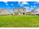 Large, grassy backyard featuring a two-story home with a patio and a fenced perimeter at 121 Pine Eagle Dr, Rock Hill, SC 29732