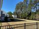 Large backyard with a fence, grassy area, storage shed, and mature trees at 121 Pine Eagle Dr, Rock Hill, SC 29732