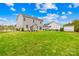 Expansive backyard with lush green grass, a fence, and a view of the home's exterior at 121 Pine Eagle Dr, Rock Hill, SC 29732