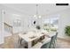 Bright dining room featuring a marble table, elegant chandelier, and large window overlooking the front yard at 121 Pine Eagle Dr, Rock Hill, SC 29732
