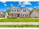 Beautiful two-story home with a combination of stone and gray siding, plus a manicured lawn at 121 Pine Eagle Dr, Rock Hill, SC 29732