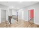 Bright hallway with wood floors, black iron railing and open doorways to colorful rooms at 121 Pine Eagle Dr, Rock Hill, SC 29732