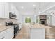 Gourmet kitchen with granite counters, stainless appliances, stone fireplace, and backyard access at 121 Pine Eagle Dr, Rock Hill, SC 29732