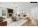 Inviting living room featuring a stone fireplace, ceiling fan, and large windows providing ample natural light at 121 Pine Eagle Dr, Rock Hill, SC 29732