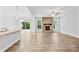 Open-concept living room with a stone fireplace and wood-look flooring at 121 Pine Eagle Dr, Rock Hill, SC 29732