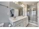 Bathroom with double vanity, framed mirrors, walk-in shower with tiled walls at 1213 Bhaltair Ln, Fort Mill, SC 29708