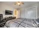 Neutral bedroom featuring a ceiling fan, TV, and closet with sliding doors at 1213 Bhaltair Ln, Fort Mill, SC 29708