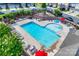 Aerial shot of the neighborhood pool with lounge chairs, umbrellas and lush landscaping at 1213 Bhaltair Ln, Fort Mill, SC 29708