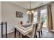 Modern dining room with glass table, chandelier, and access to outdoor patio at 1213 Bhaltair Ln, Fort Mill, SC 29708