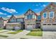 A row of attractive townhomes are showcased with well manicured lawns on a sunny day at 1213 Bhaltair Ln, Fort Mill, SC 29708