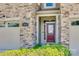 Close up of a lovely front door flanked by stone and a garage door at 1213 Bhaltair Ln, Fort Mill, SC 29708