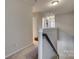 Upstairs hallway with neutral carpet and a view of multiple bedrooms at 1213 Bhaltair Ln, Fort Mill, SC 29708