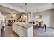 Eat-in kitchen showcases an island with bar seating in an open floor plan with hardwood flooring at 1213 Bhaltair Ln, Fort Mill, SC 29708