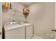 Functional laundry room with washer, dryer, and wire shelving for storage at 1213 Bhaltair Ln, Fort Mill, SC 29708