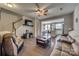 Spacious living room features a ceiling fan, stairs to the upper level and a view to the kitchen at 1213 Bhaltair Ln, Fort Mill, SC 29708