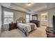 Spacious main bedroom with tray ceiling, large windows, and neutral decor at 1213 Bhaltair Ln, Fort Mill, SC 29708