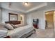 Bright main bedroom featuring a tray ceiling, dresser, and an ensuite bathroom at 1213 Bhaltair Ln, Fort Mill, SC 29708