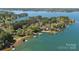 Breathtaking aerial view of lakefront property with mature trees, private docks, and serene water at 126 Balmoral Dr, Mooresville, NC 28117