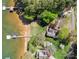 Stunning aerial view of a lakeside property with a private dock and lush green landscape at 126 Balmoral Dr, Mooresville, NC 28117