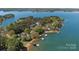 Breathtaking aerial view of homes nestled on a lush peninsula surrounded by pristine blue waters at 126 Balmoral Dr, Mooresville, NC 28117