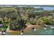 Expansive lakefront property featuring lush trees and a private dock at 126 Balmoral Dr, Mooresville, NC 28117