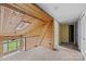 Open attic featuring wood paneling, a skylight and a transition to carpeted hallway with closet at 126 Balmoral Dr, Mooresville, NC 28117