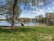 Lush grassy lawn extending to a private dock with covered area and scenic lake views at 126 Balmoral Dr, Mooresville, NC 28117