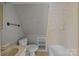 Bathroom featuring a toilet, tub, vanity and geometric patterned wall at 126 Balmoral Dr, Mooresville, NC 28117