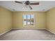 Bedroom featuring a scenic lake view, complemented by a ceiling fan and neutral decor at 126 Balmoral Dr, Mooresville, NC 28117