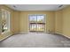 Bedroom with neutral paint, new carpet, and a sliding glass door to the balcony at 126 Balmoral Dr, Mooresville, NC 28117