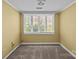Bedroom featuring neutral paint, carpet, and a large window allowing for natural light at 126 Balmoral Dr, Mooresville, NC 28117